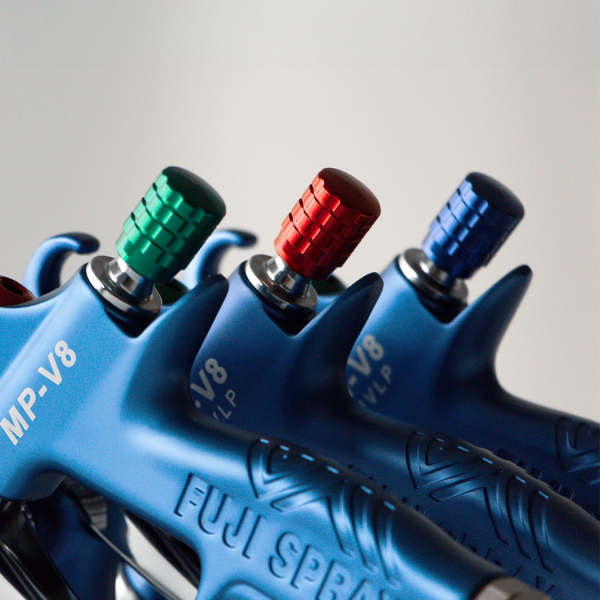 Close up of Color Coded Fluid Control Knobs on guns