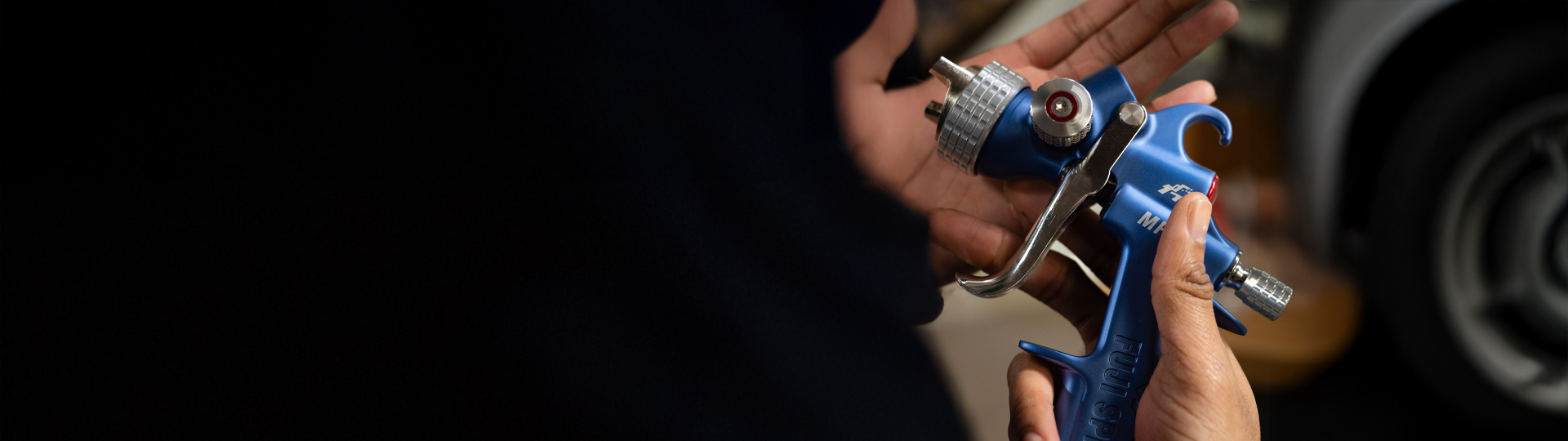 a hand holding our spray gun MP-V8