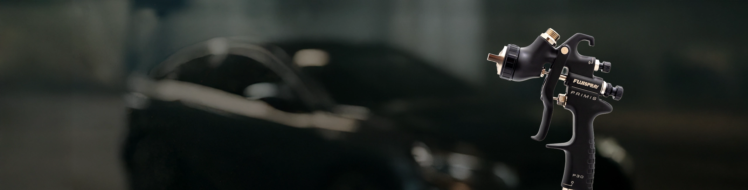 Primis P30 spray gun in front of a black car