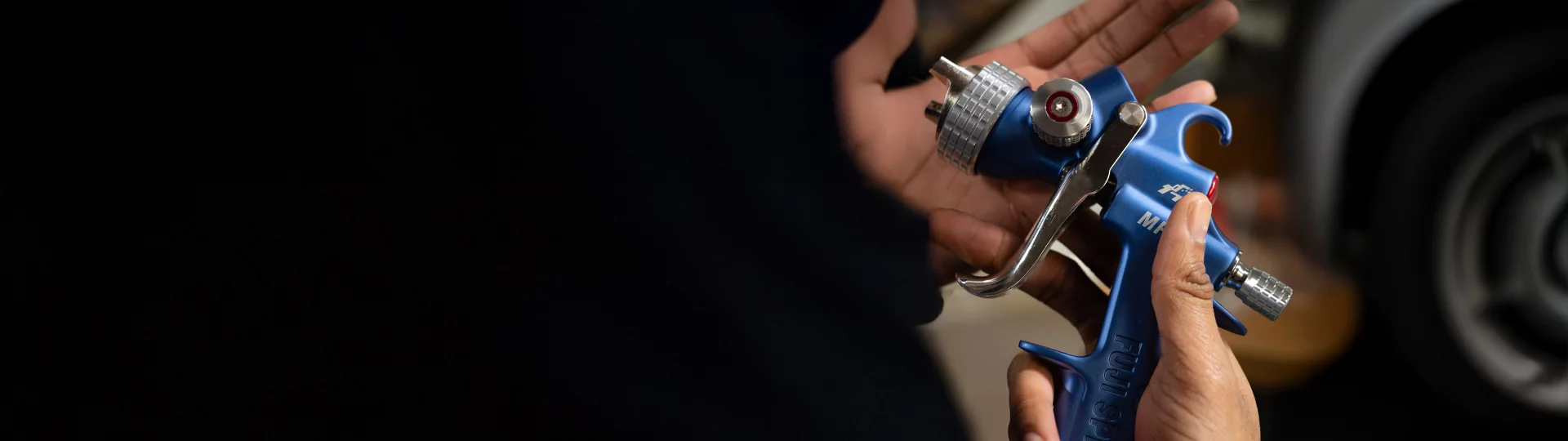 a hand holding our spray gun MP-V8